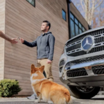 Man with dog hands keys to a Mercedes-Benz technician
