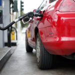 Red car at a gas pump