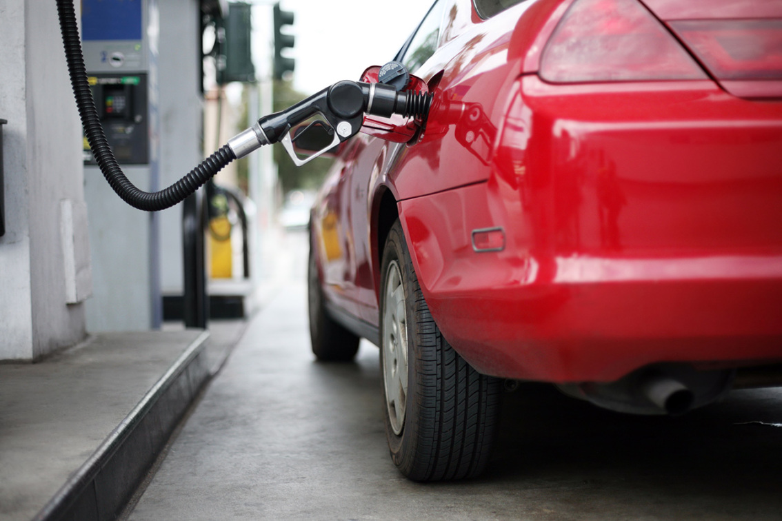 Red car at a gas pump